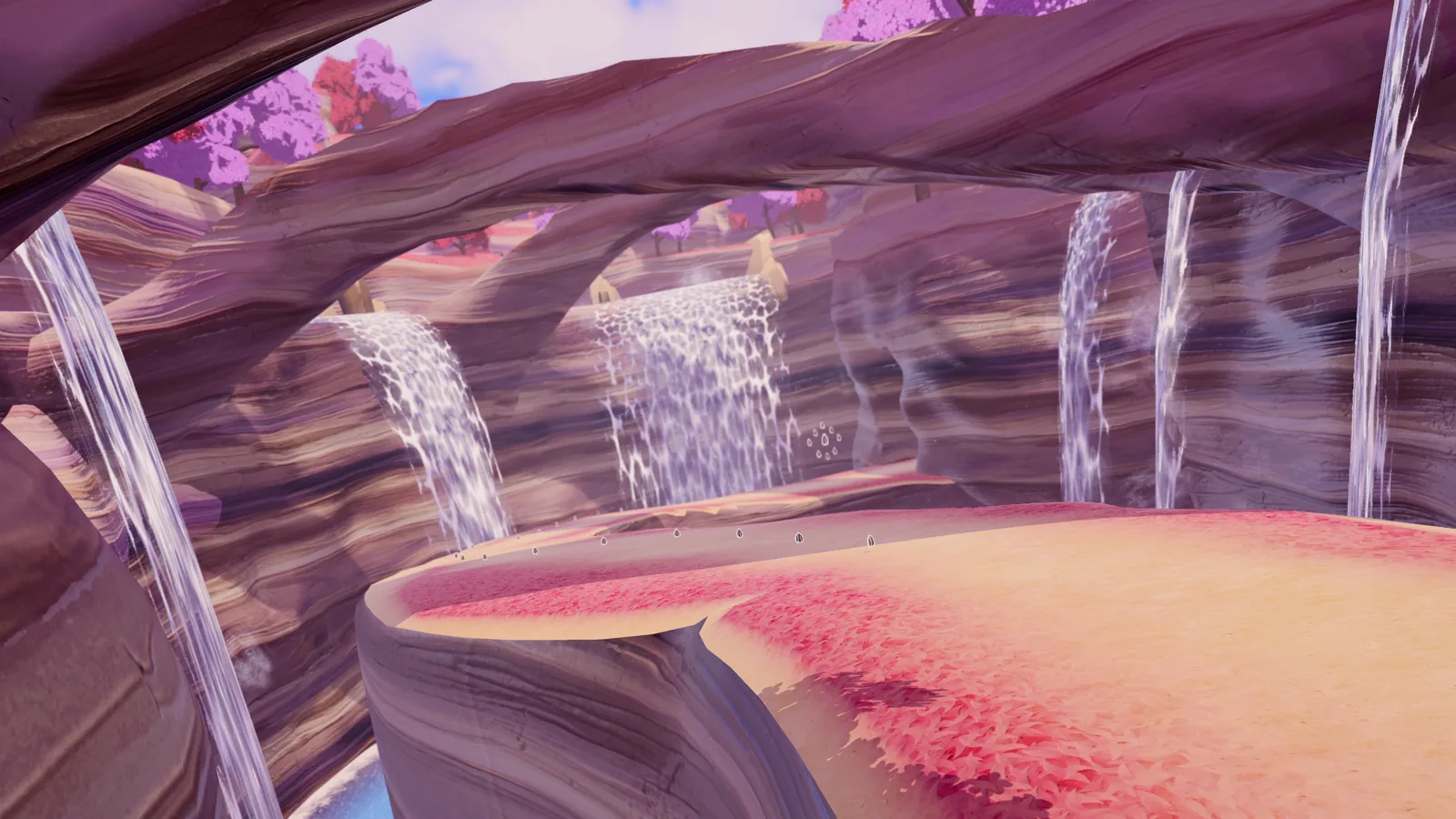 Waterfalls pouring through carved canyon arches